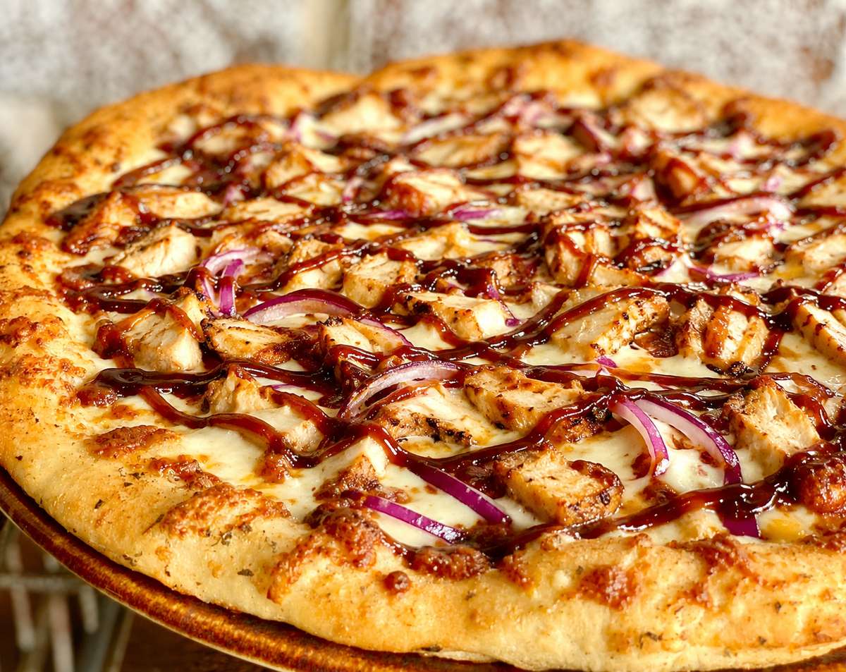 Gaslight BBQ Sauce, Mozzarella, Chicken, Red Onion, Provolone cheese, BBQ drizzle.