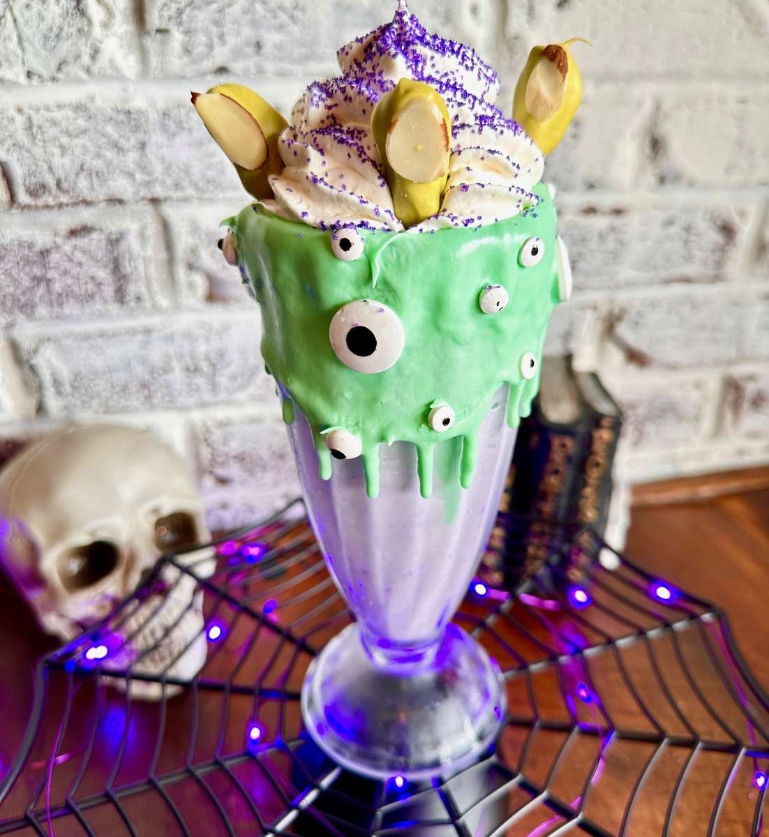 With eye of newt and toe of frog placed into our couldron, Just kidding... This delightfully spooky blackberry potion is sure to delight. Topped with white chocolate coated cinnamon pretzel witchy fingers