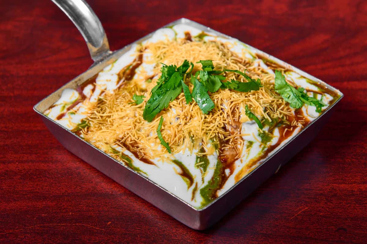 Samosa chole at Dhaba Express Parsippany NJ, crispy samosas topped with spiced chickpea curry and chutneys