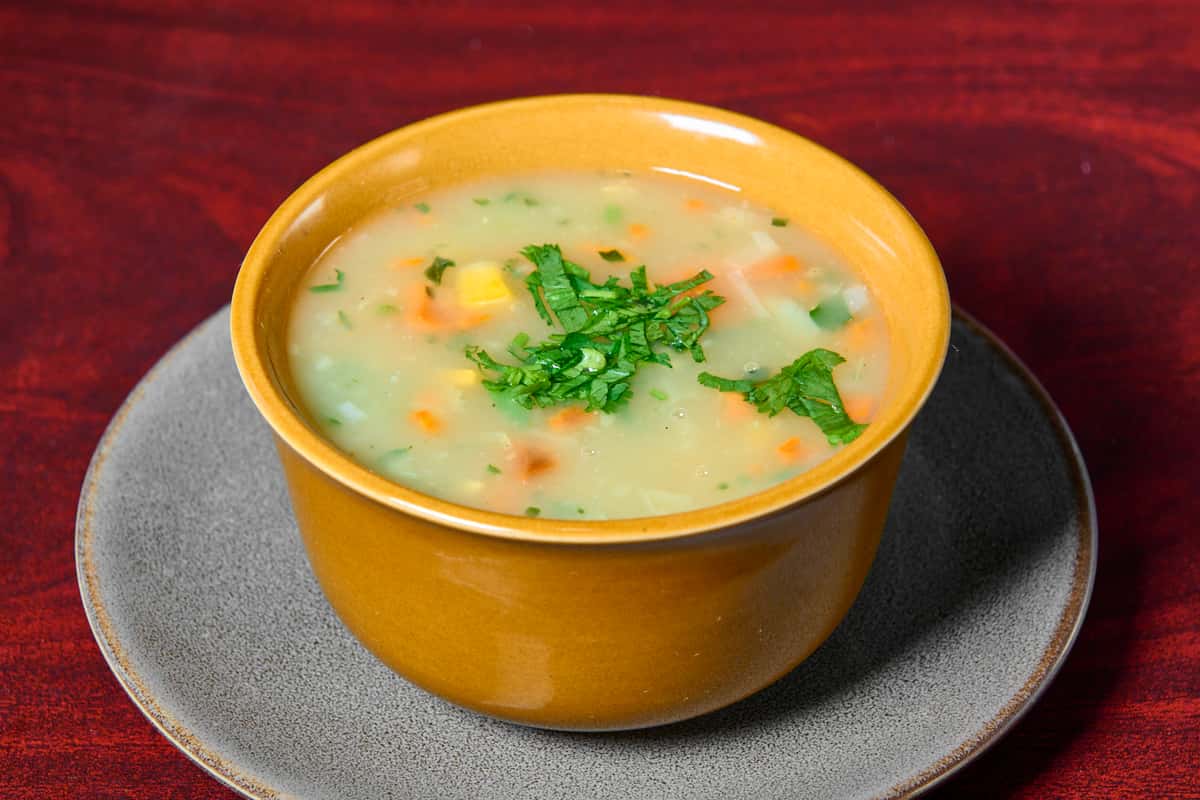 Vegetable sweet corn soup at Dhaba Express in Parsippany NJ, a light Indo-Chinese soup with corn and fresh herbs