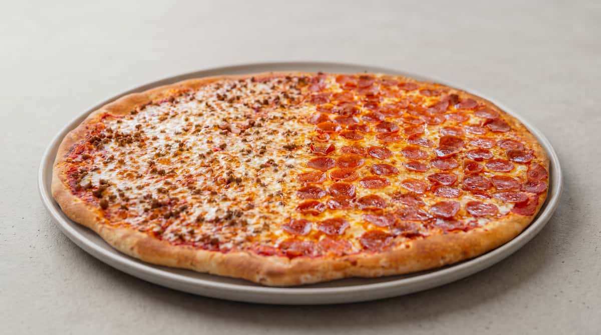 Large pizza, half pepperoni and half ground beef, with melted cheese.