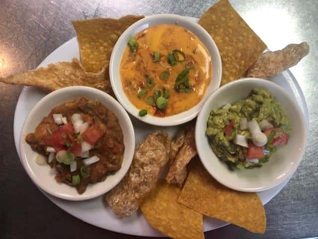nachos with guacamole, queso and salsa