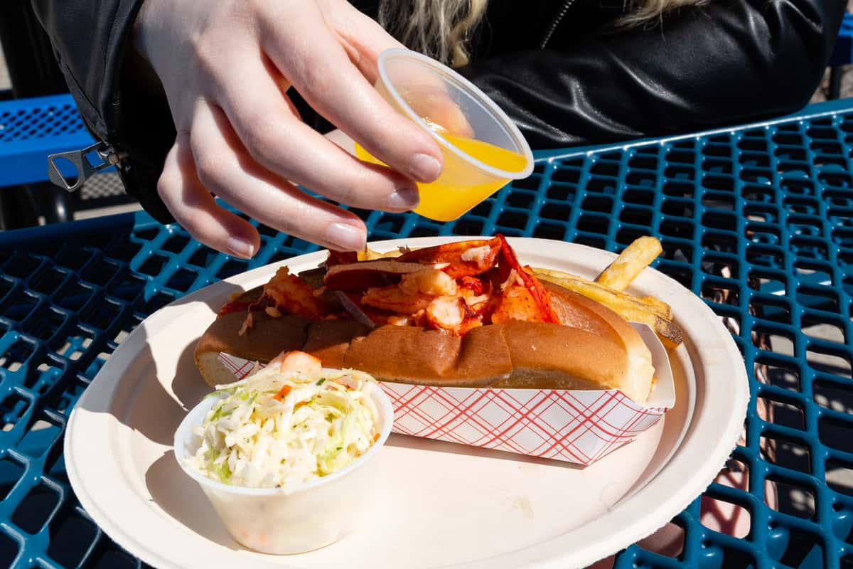 pouring butter on lobster roll