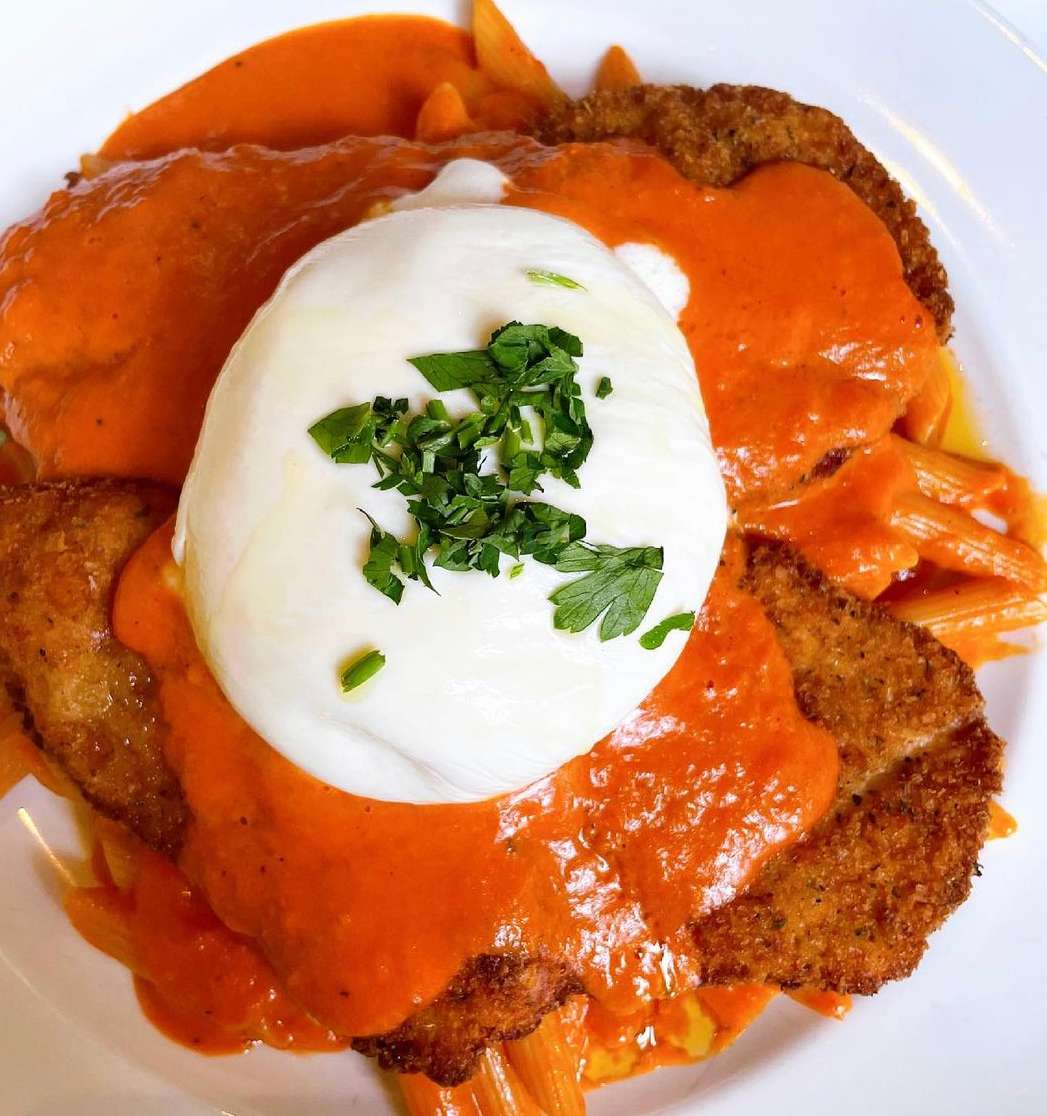 Breaded Chicken Cutlet Over Penne In a Vodka Sauce Topped with a Homemade Burrata.