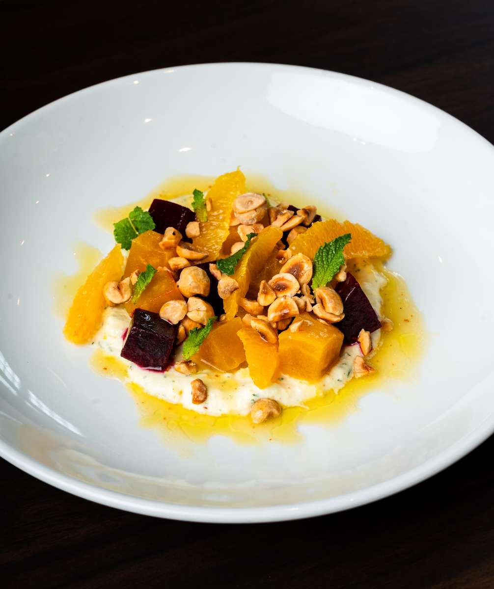 Seasonal beet and citrus salad with herbs, nuts, and creamy cheese at Oxford Place restaurant