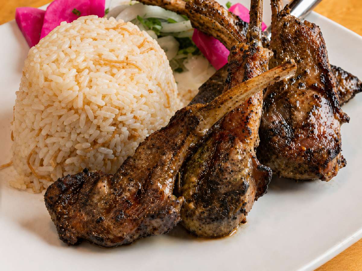 Grilled lamb chops served with seasoned rice and pickled vegetables