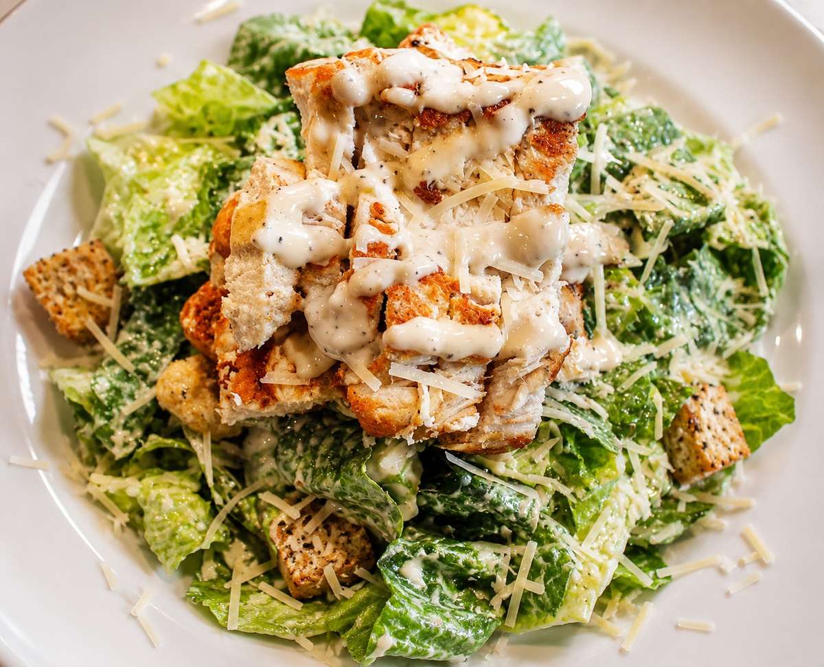 Grilled chicken Caesar salad with romaine lettuce, croutons, Parmesan, and creamy dressing