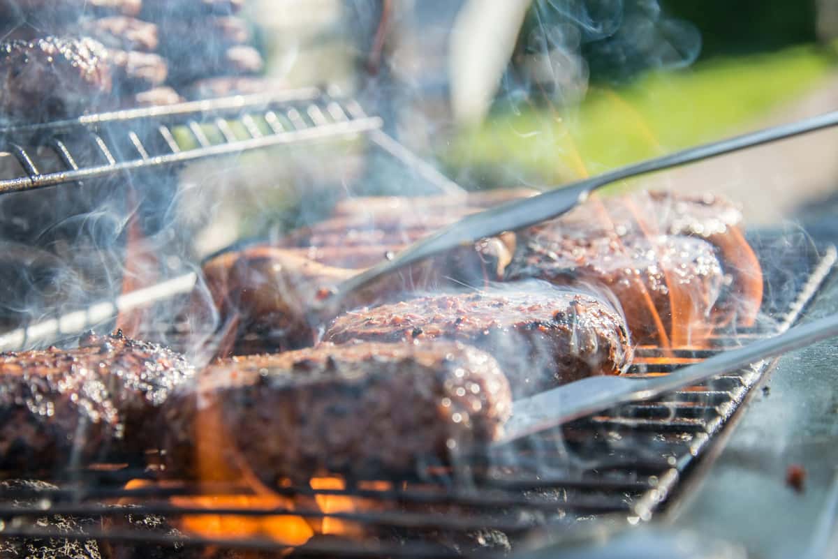 Smoky, sizzling burgers are being flipped on a grill at City Limits Bar and Grill.