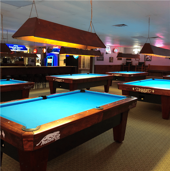 interior view of business with pool tables and lights up above