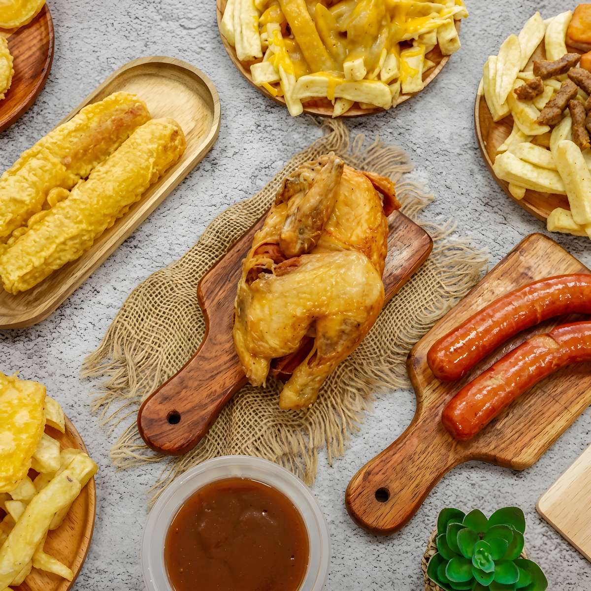 Roast chicken and sausages served alongside thick-cut chips, battered favorites, gravy, and loaded fries