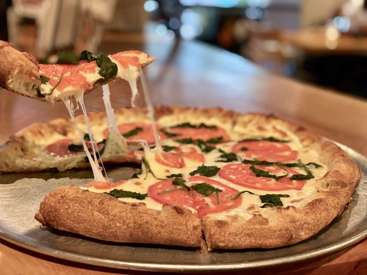 Cheese pull from a margherita pizza