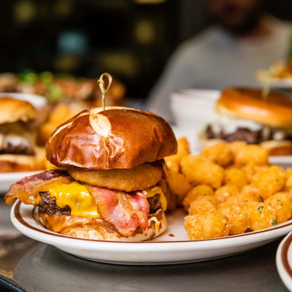 a bacon cheeseburger with a side of tater tots