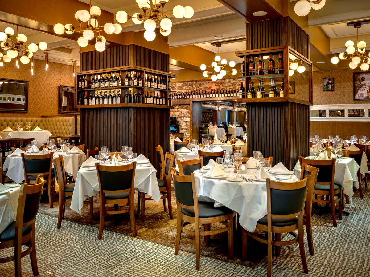 Interior seating with laid tables and warm lighting