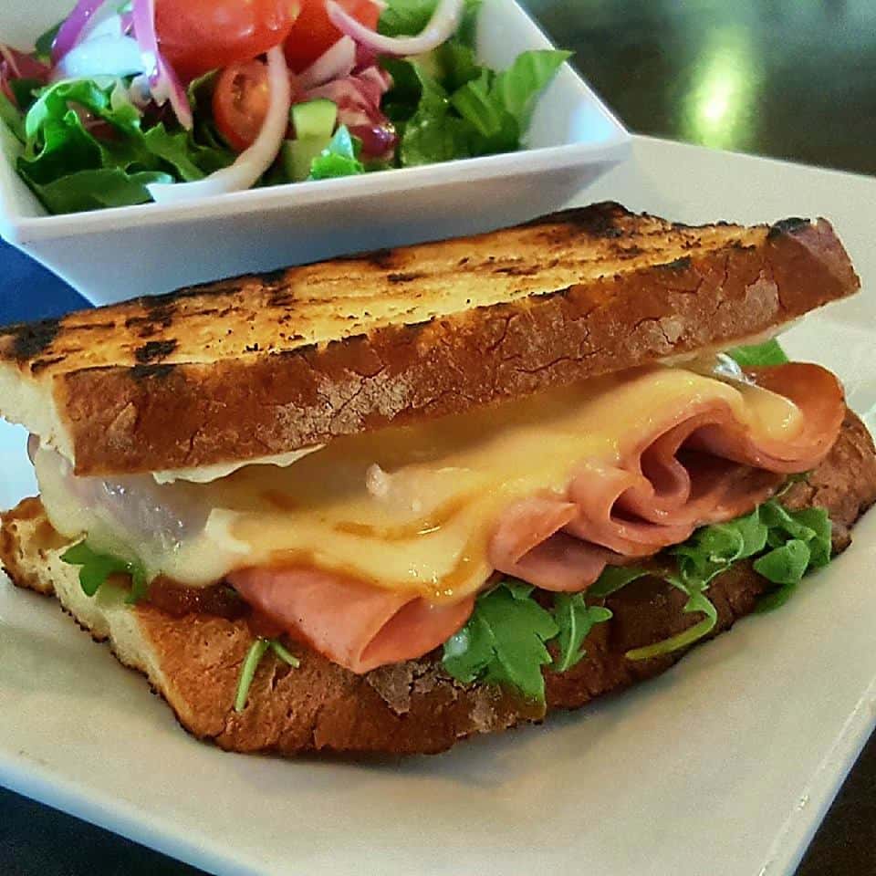 ham and cheese sandwich with lettuce with a side salad