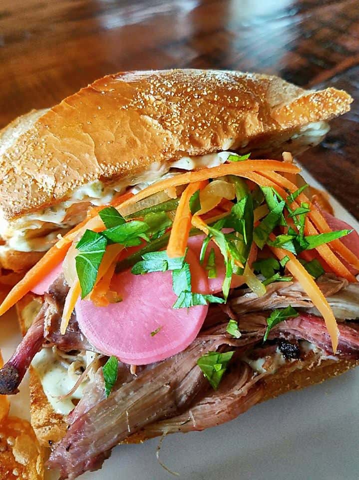 pulled pork sandwich on a roll with coleslaw