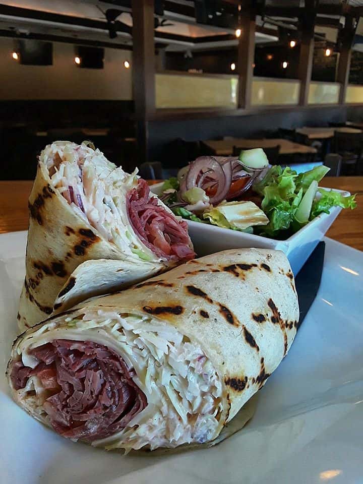 pulled pork wrap with coleslaw and a side salad