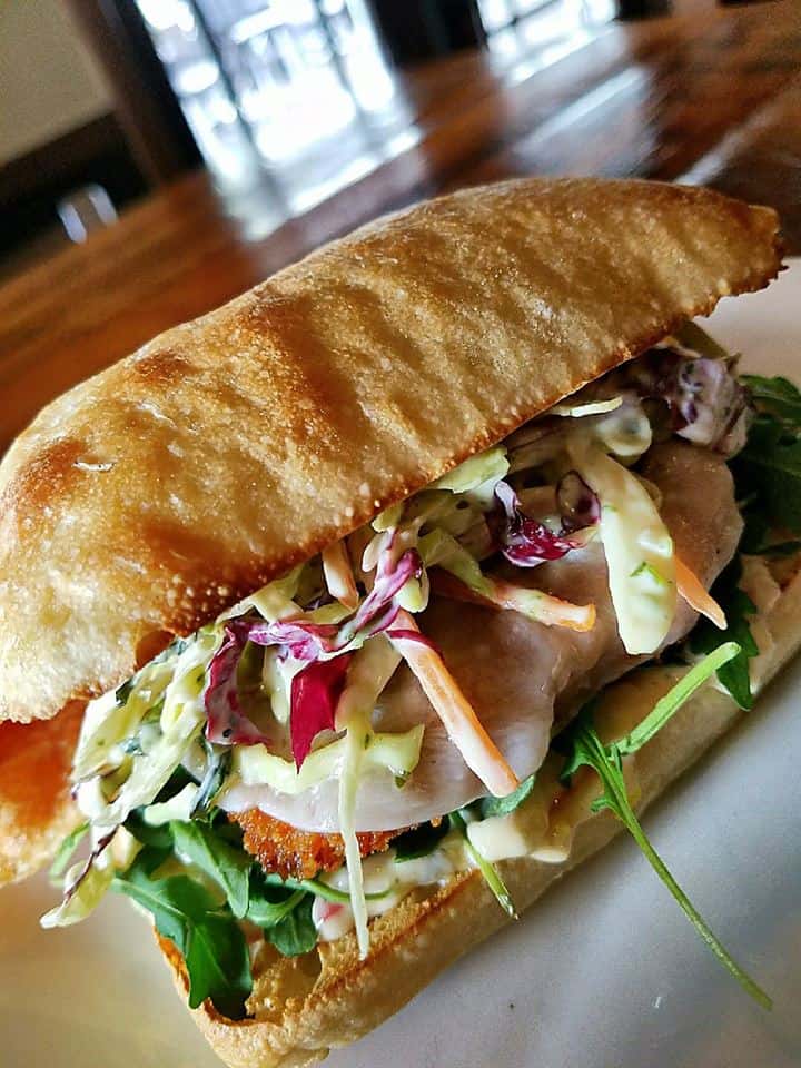 fried chicken sub with cheese, coleslaw and spinach