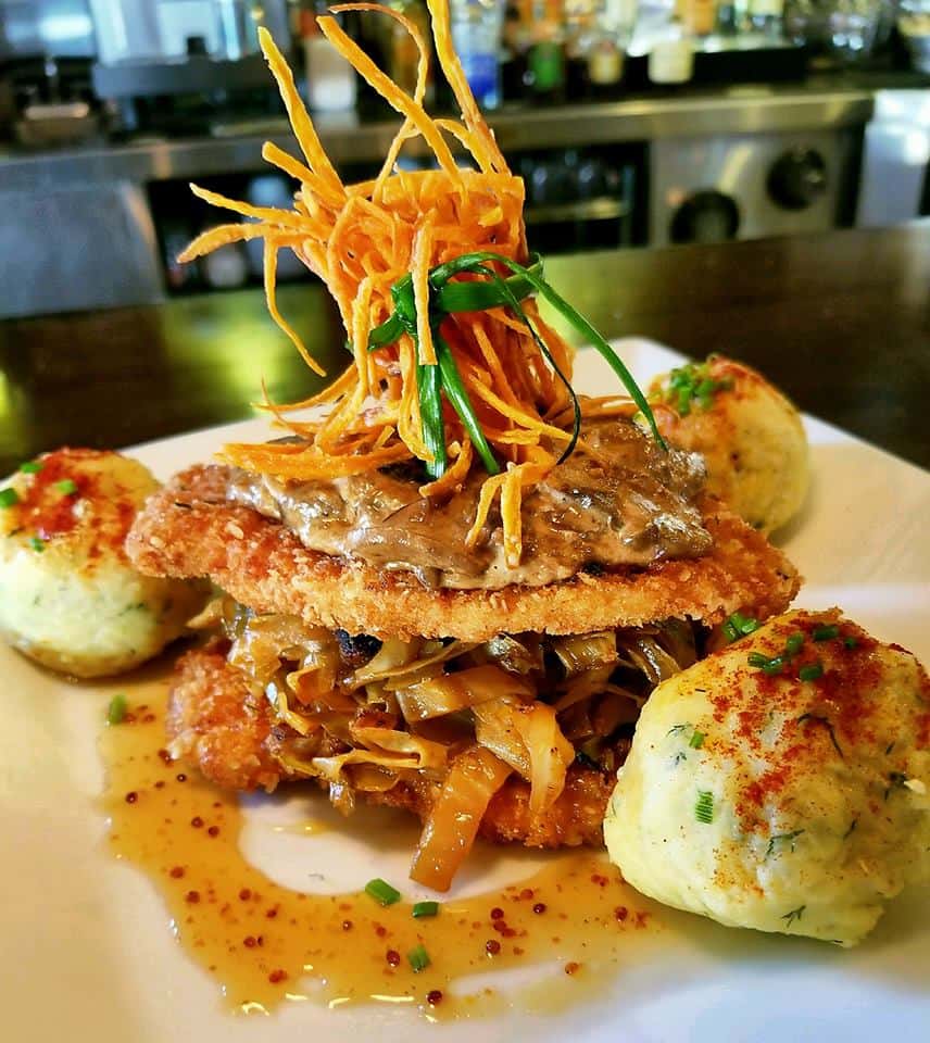 fried chicken sandiwch with dumplings and vegetables