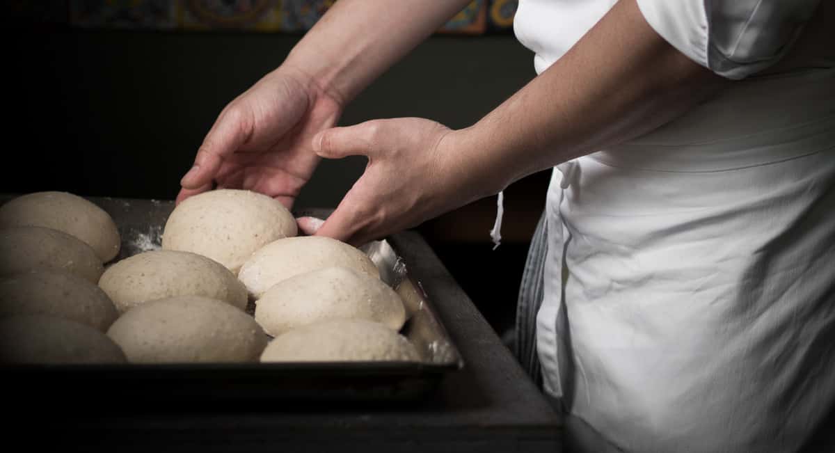chef placing dough in pan