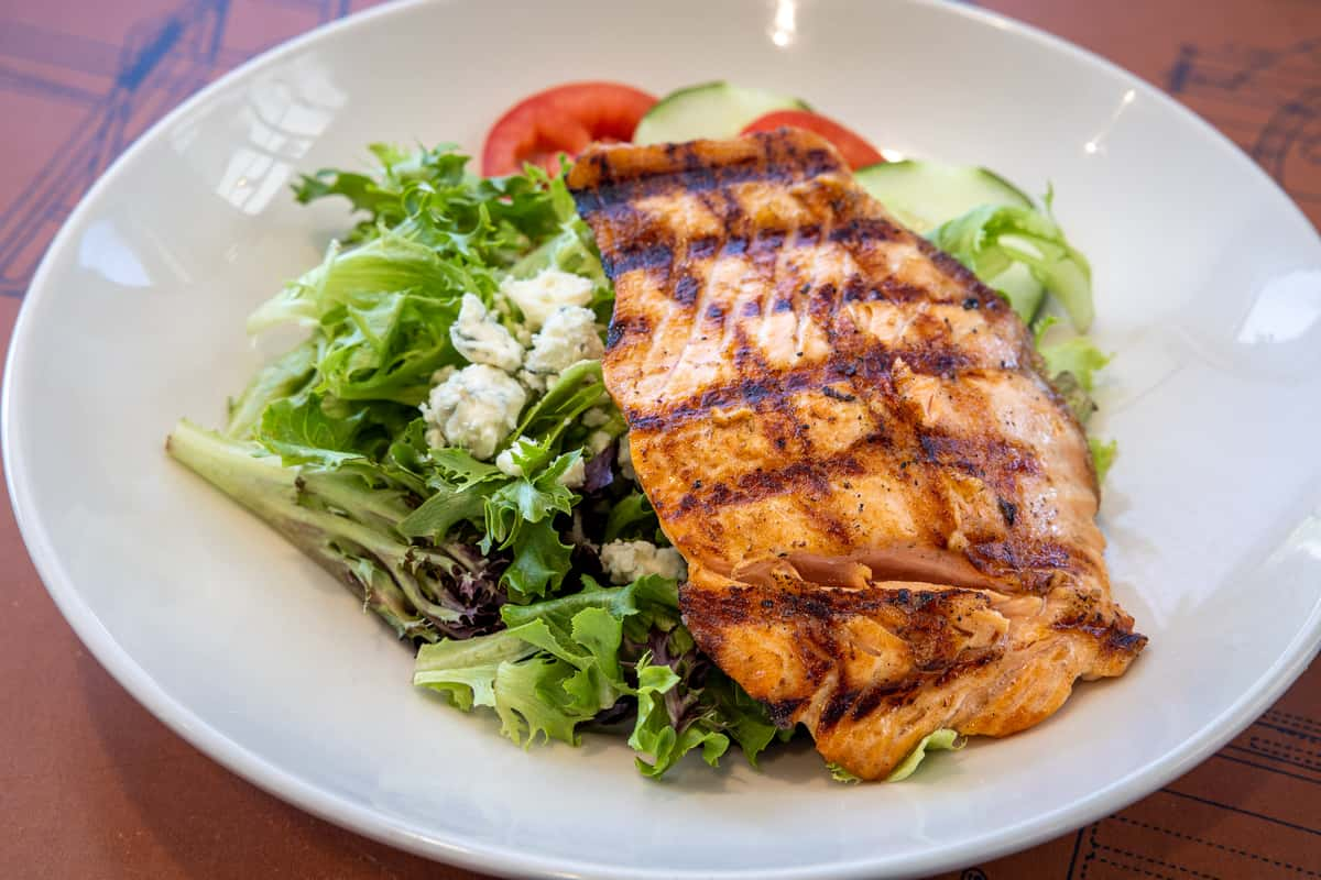 Charbonos - Light, fresh, and full of flavor! Our Capri Salmon salad is a  filling salad option on our menu for lunch and dinner.