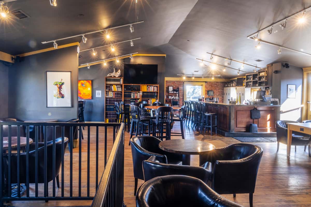 Photo of the upstairs "Teacher's Lounge" seating area, with the upstairs bar in the background. Photo Credit: The Bacyard.