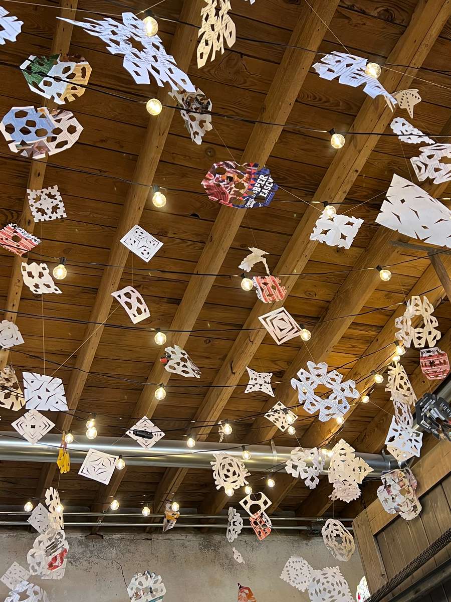 Exposed wood ceiling with hanging paper art craft