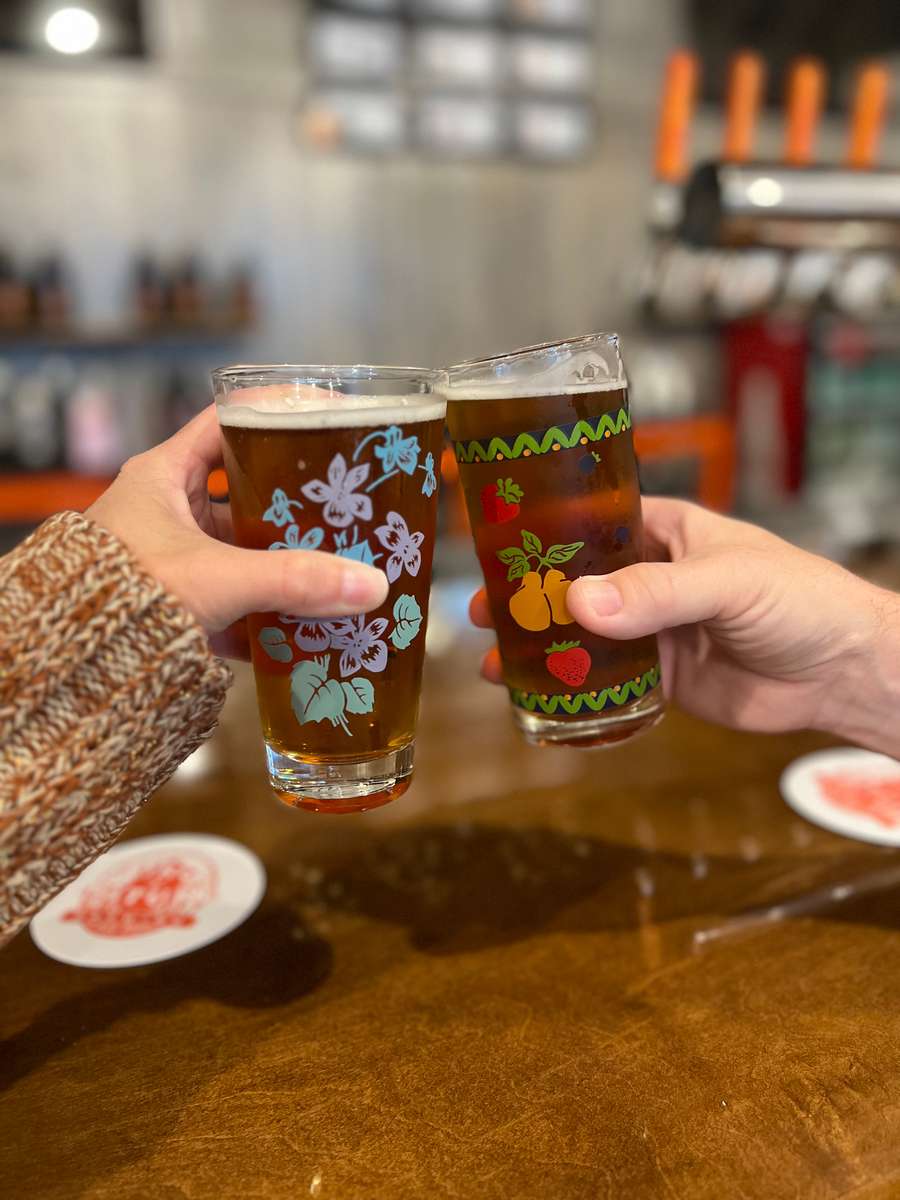 Two guests toasting with beer