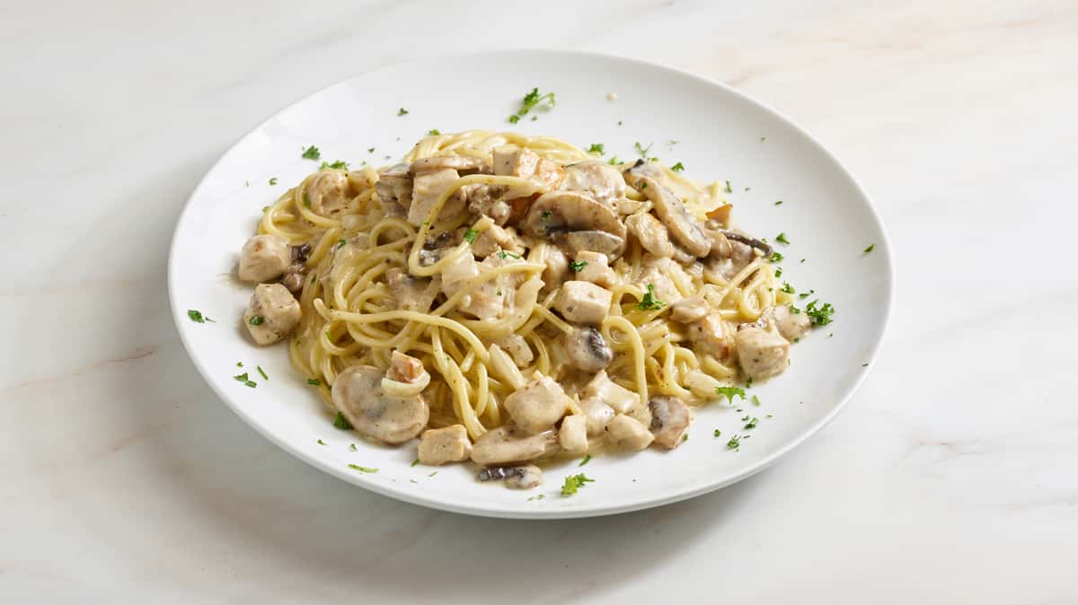 Herb roasted free range chicken breast morsels and mushrooms simmered in a light white wine and shallot crème sauce tossed with al dente pasta