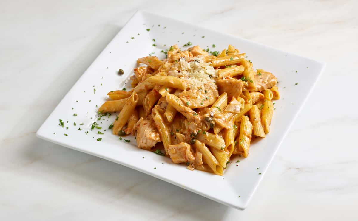 Baked salmon morsels, capers, and shallots in a creamy rosé sauce and tossed with penne al dente