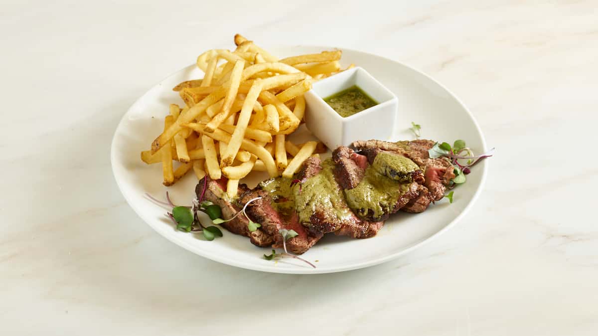 Prime Angus filet mignon slices drizzled with our magical green sauce from Paris. Served with fries