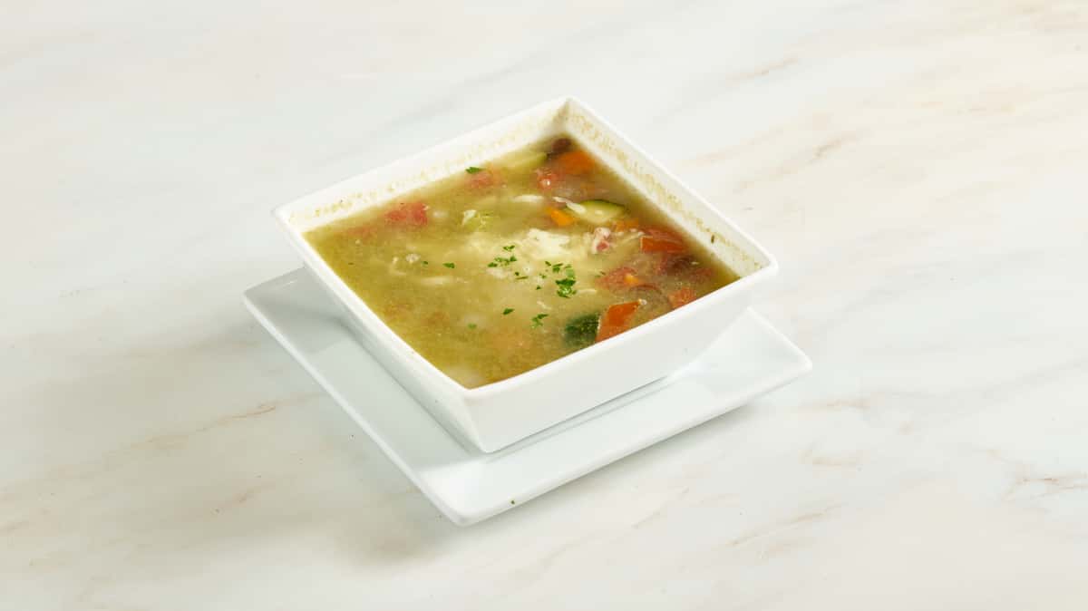 Pistou Soup. French vegetable soup with red beans, macaroni, pesto, and swiss emmental cheese