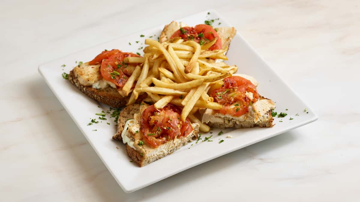 Chicken Tzatziki Tartine. With roasted tomatoes, coriander, lemon juice, and pequin chili pepper