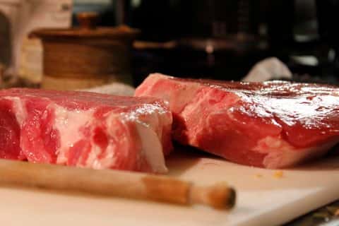 uncooked steak on a cutting board