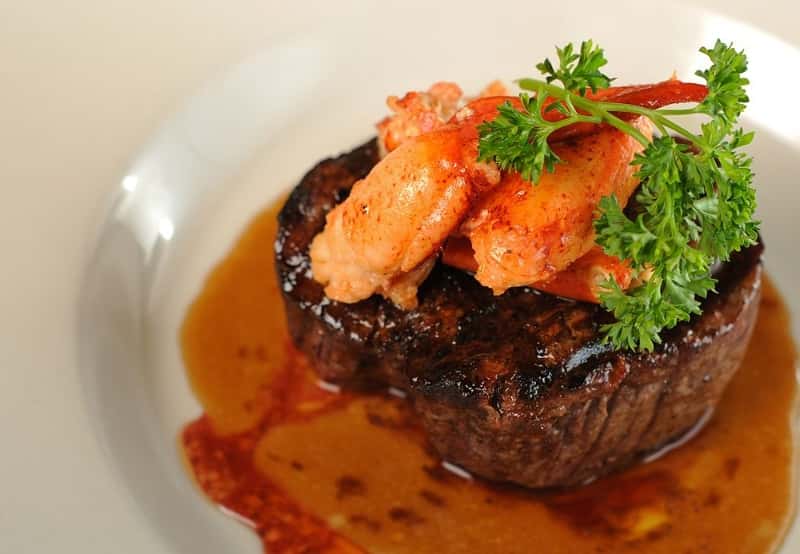 Steak with lobster claws and parsley