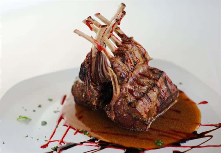 RACK OF LAMB: roasted New Zealand rack, red wine demi-glace, raspberry sauce