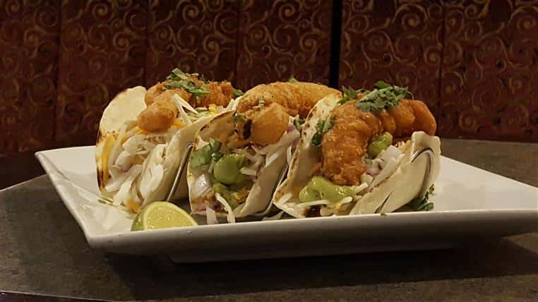Baja Fish Tacos: Battered cod, chipotle slaw, cheese, lime crema, salsa, cilantro. 