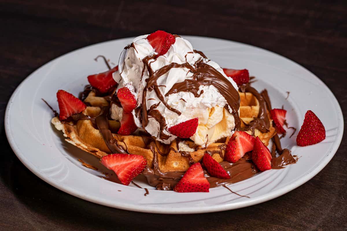 Dessert with chocolate, waffle and strawberries