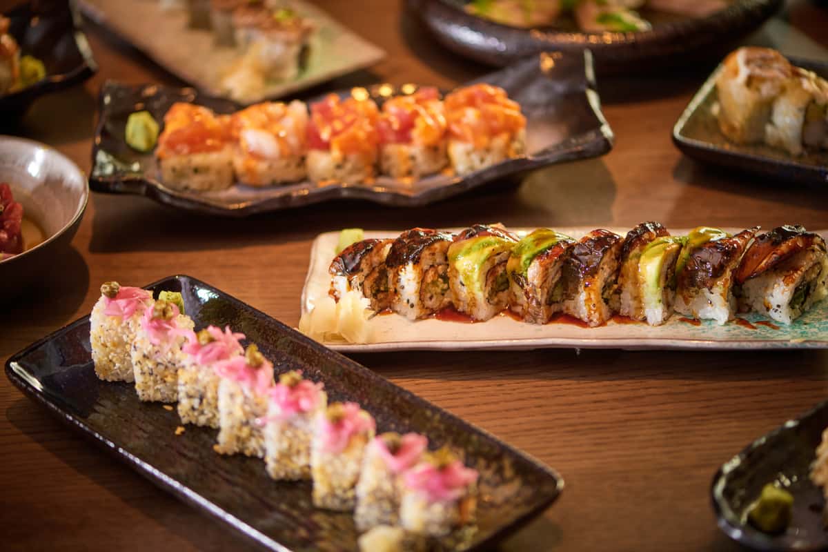 Assorted sushi rolls, sashimi, and nigri at Kumi