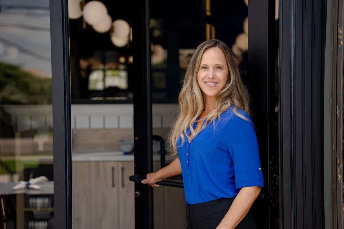Store owner standing at an entrance to a building