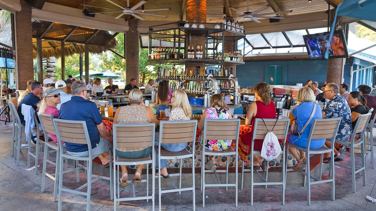 Group of guests enjoying food and beverage at the Tiki Bar