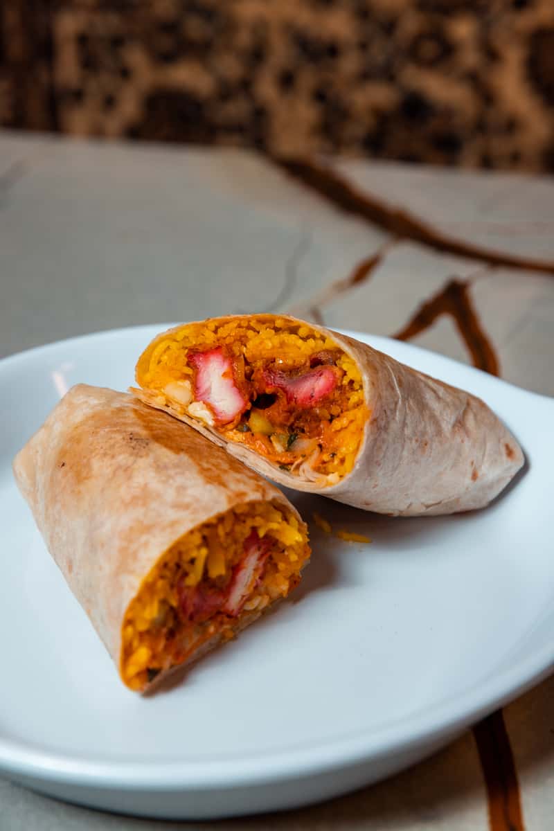 Experience Fusion Cuisine: Order the Tandoori Wrapper Online - Saffron rice, tandoori chicken, and delicious chutneys.
