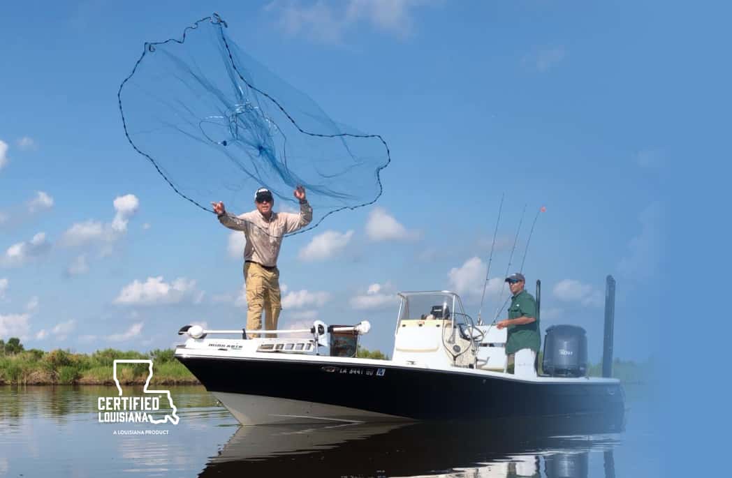 Man casting a fishing net from a boat