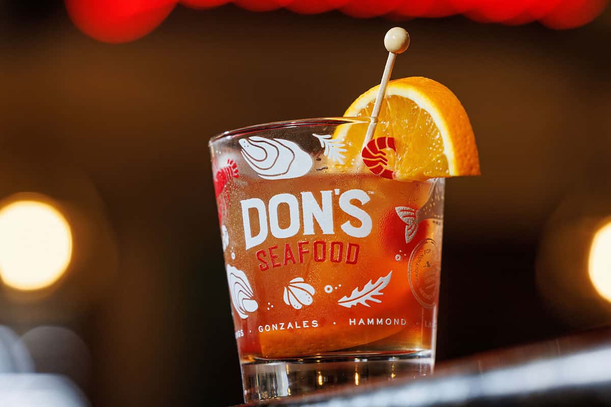 An Old Fashioned cocktial served in a branded Don's Seafood glass