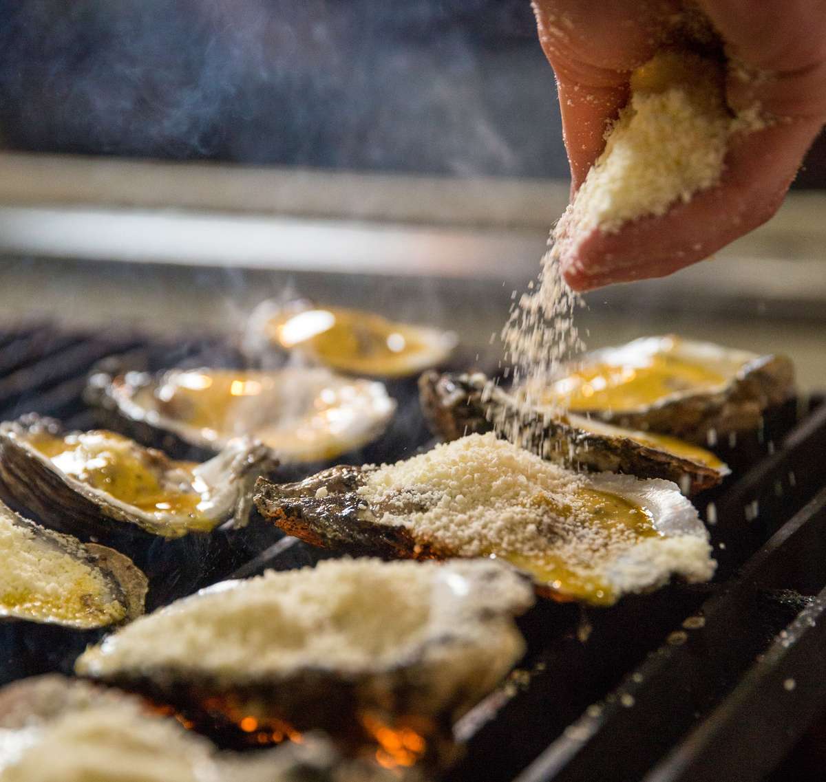 Hand topping oysters with garnish