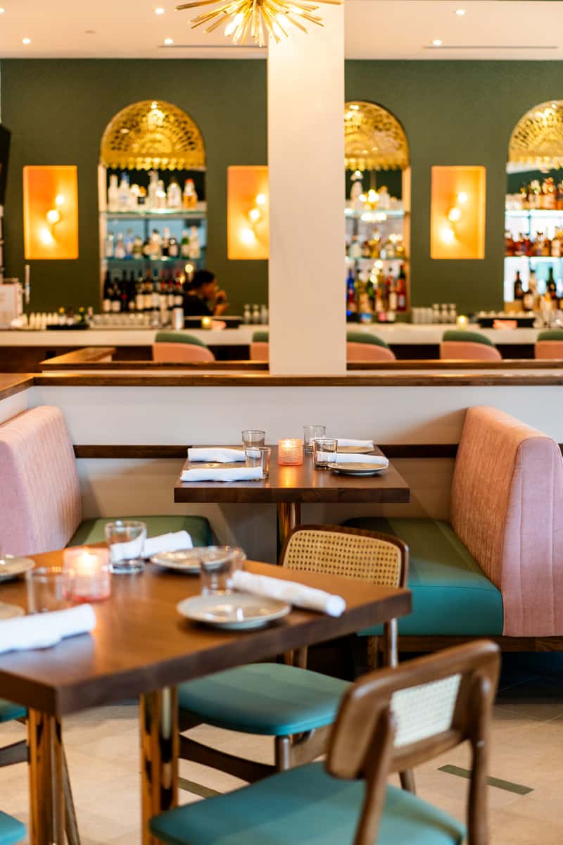 Comfortable booth and plush chair dining with a stylish bar
