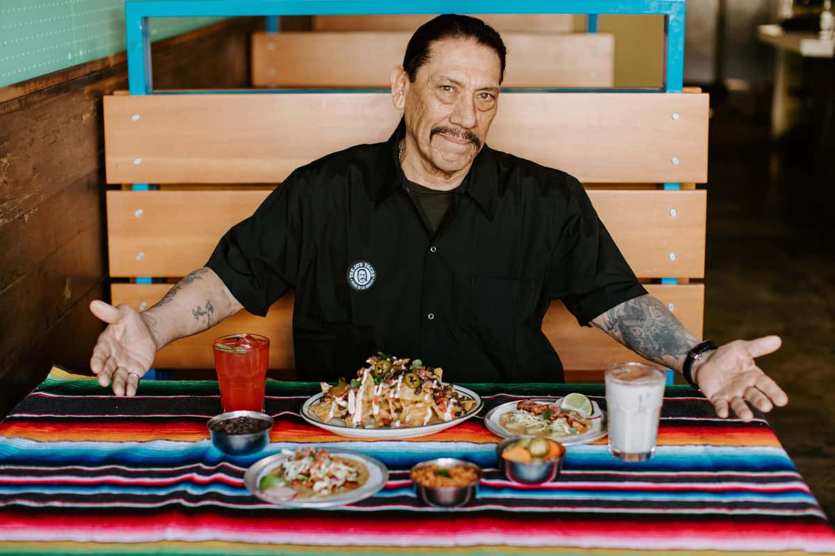 Danny Trejo with a table of food