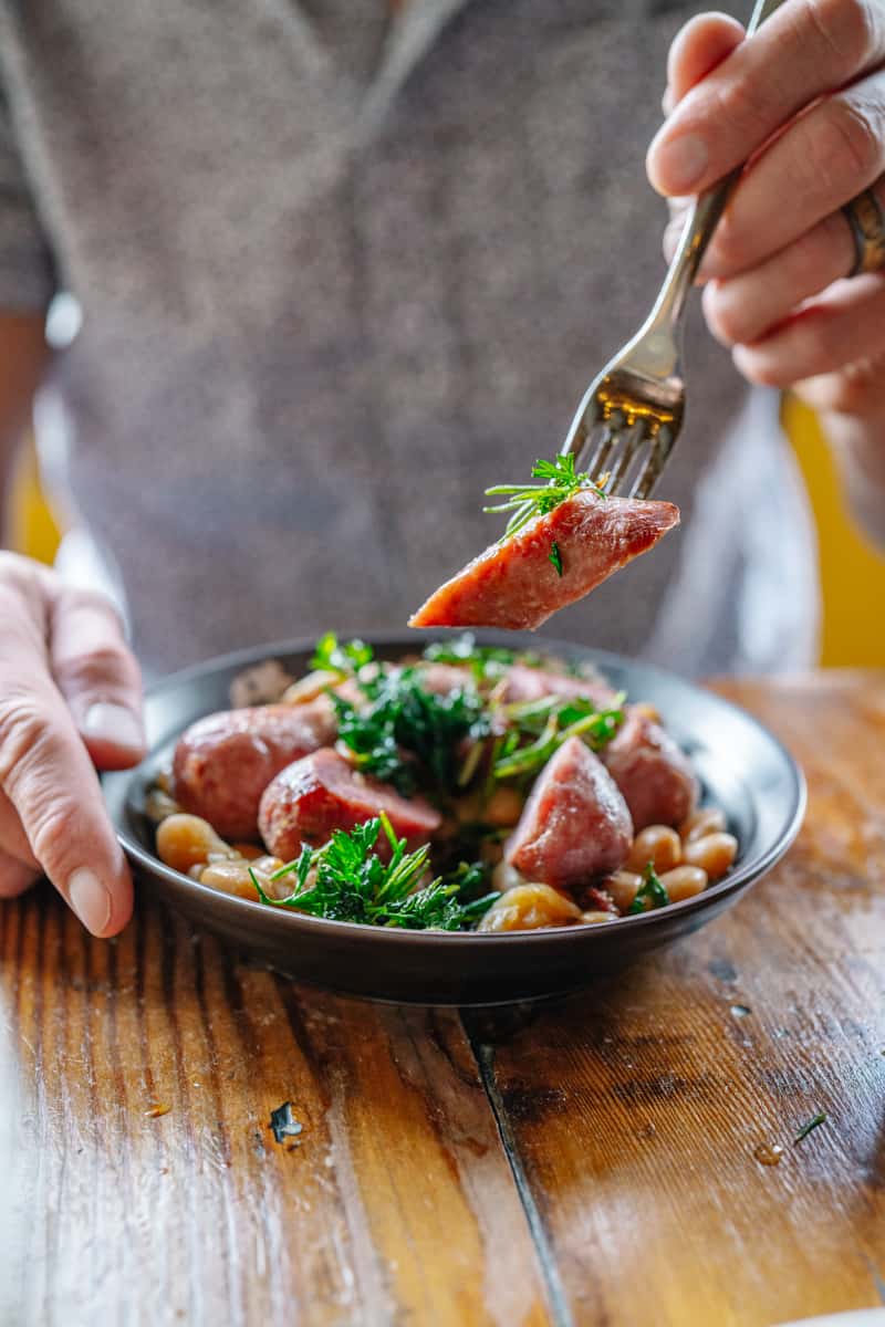 A person with a fork taking food from a bowl
