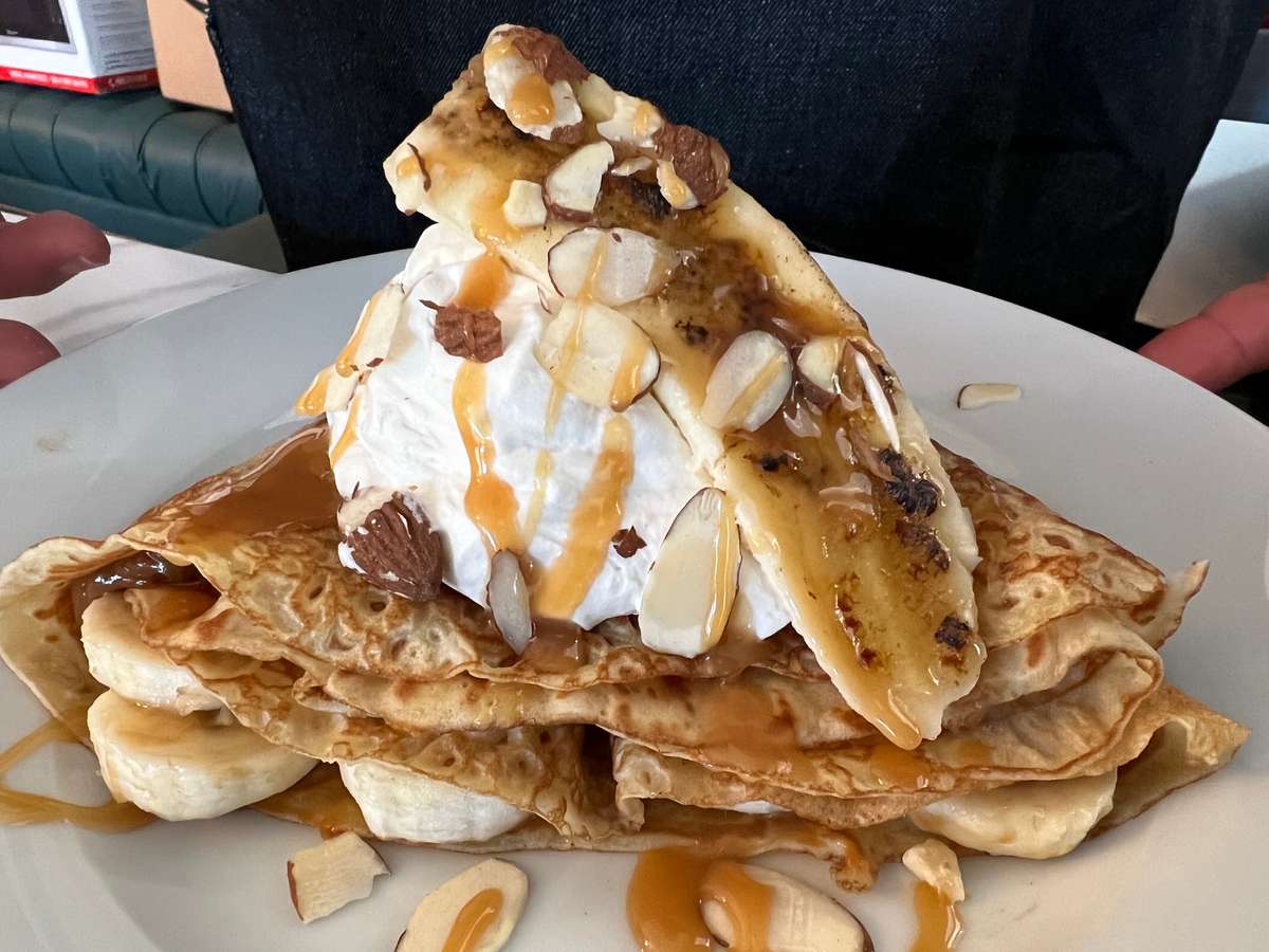 Bananas and whipped cream on top of a crepe