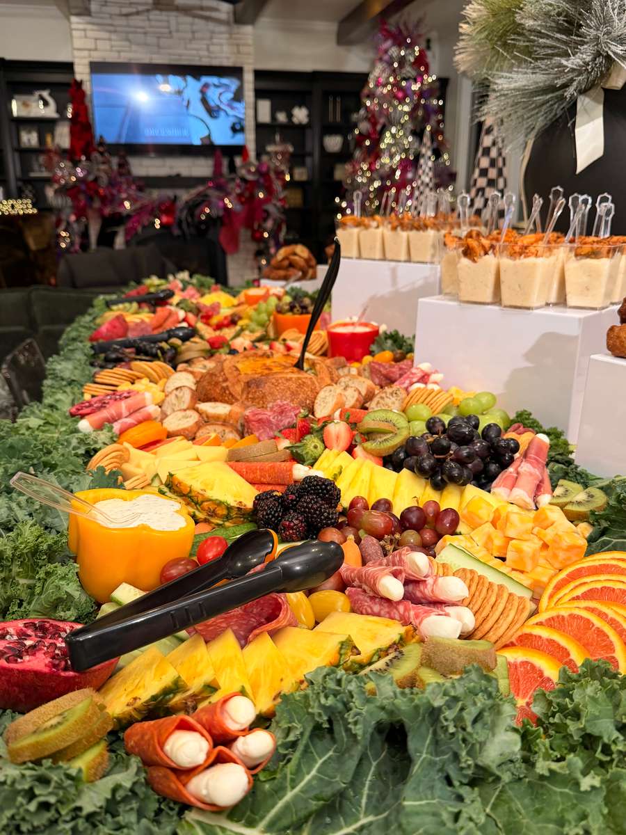 Large grazing table with fruit and cheeses
