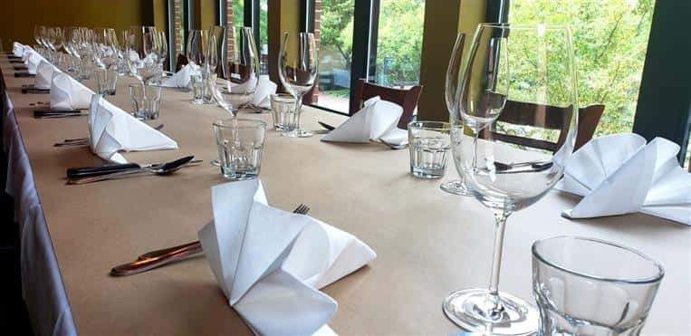 empty wine glasses on a table with folded napkins and utensils
